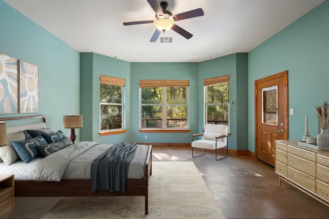 a bedroom with a bed and ceiling fan
