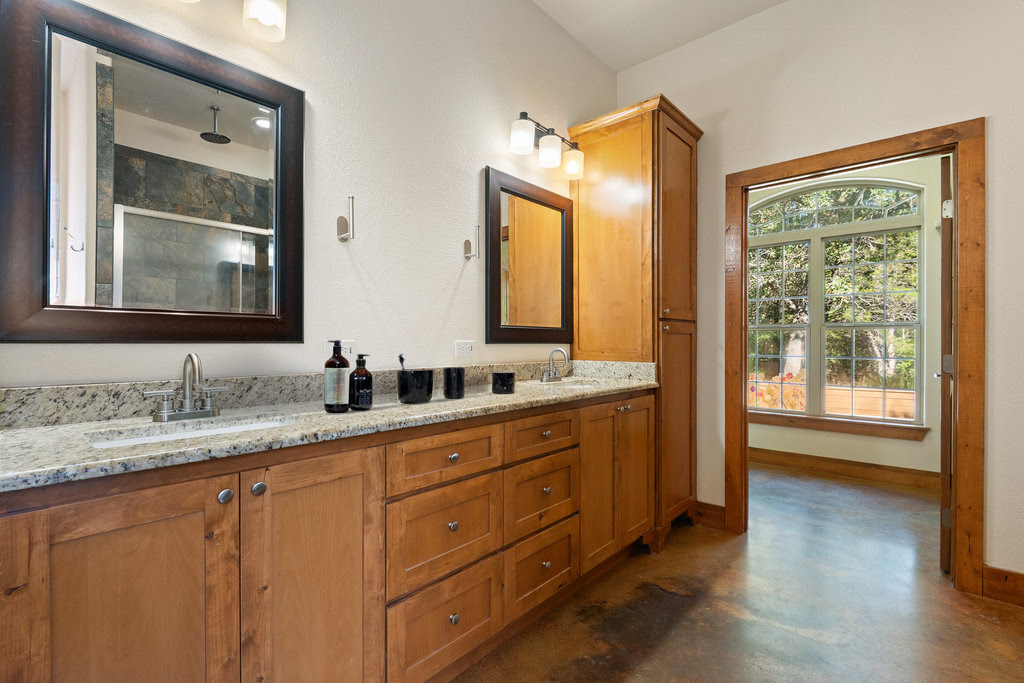 267 Corral Road Smithville, TX 78957 - Photo 27 of 40 a bathroom with a granite countertop sink mirror and double