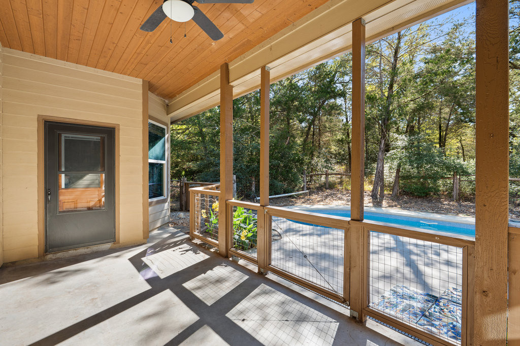 267 Corral Road Smithville, TX 78957 - Photo 37 of 40 a living room with a floor to ceiling window and chairs