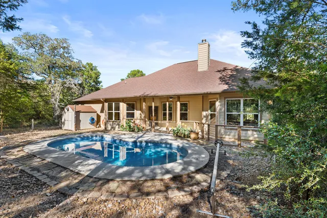 a backyard of a house with table and chairs