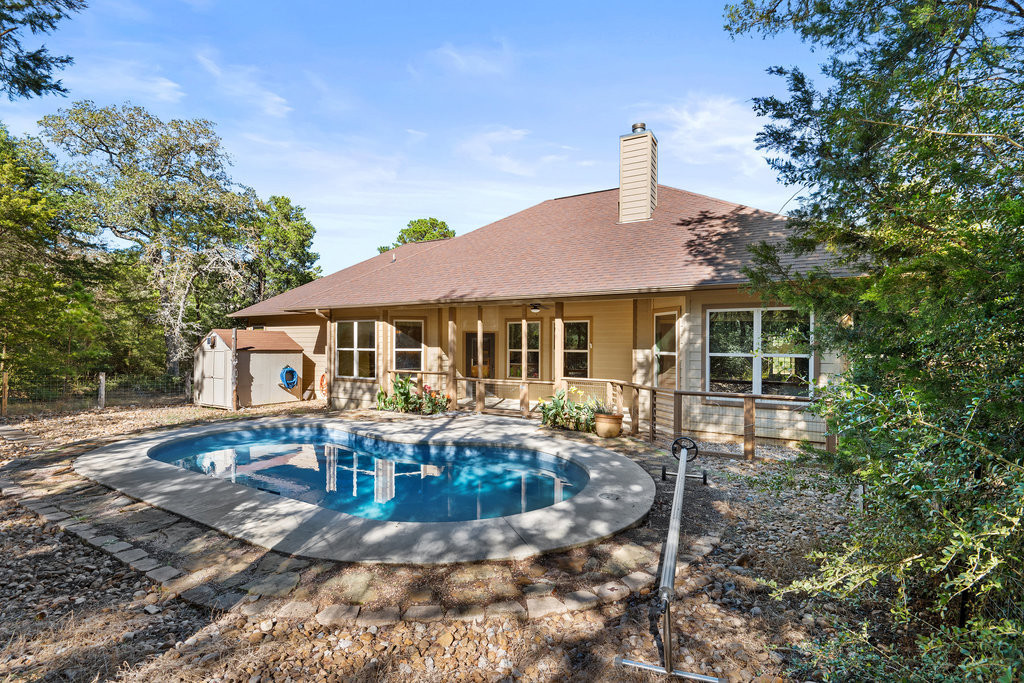 267 Corral Road Smithville, TX 78957 - Photo 38 of 40 a front view of house with yard outdoor seating and barbeque oven
