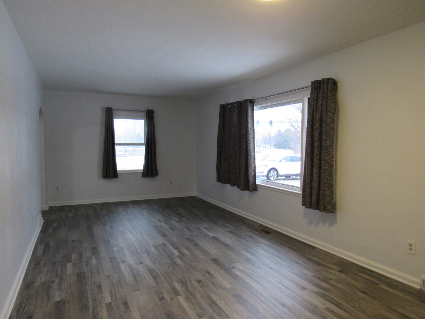 730 Lincoln Road Bettendorf, IA 52722 - Photo 2 of 13 an empty room with wooden floor and windows