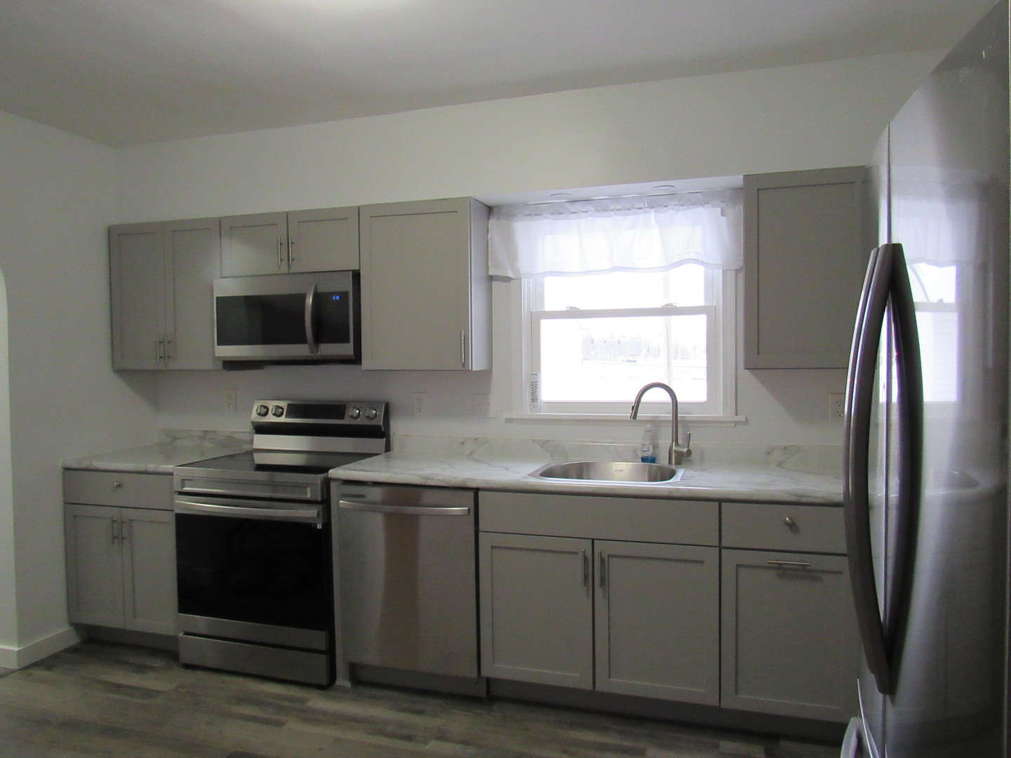 730 Lincoln Road Bettendorf, IA 52722 - Photo 4 of 13 a kitchen with stainless steel appliances granite countertop a sink stove and refrigerator