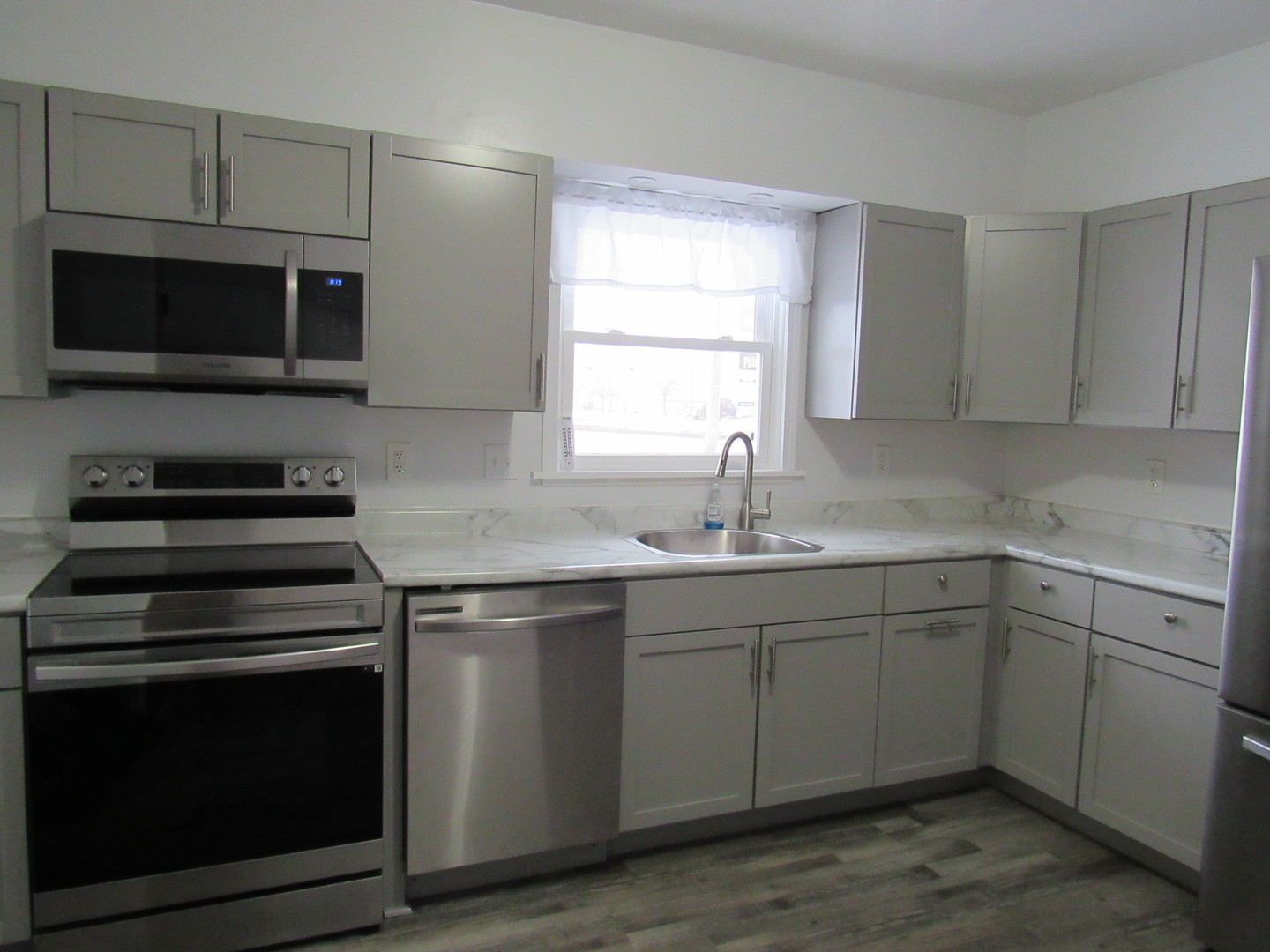 730 Lincoln Road Bettendorf, IA 52722 - Photo 5 of 13 a kitchen with a sink stove and microwave