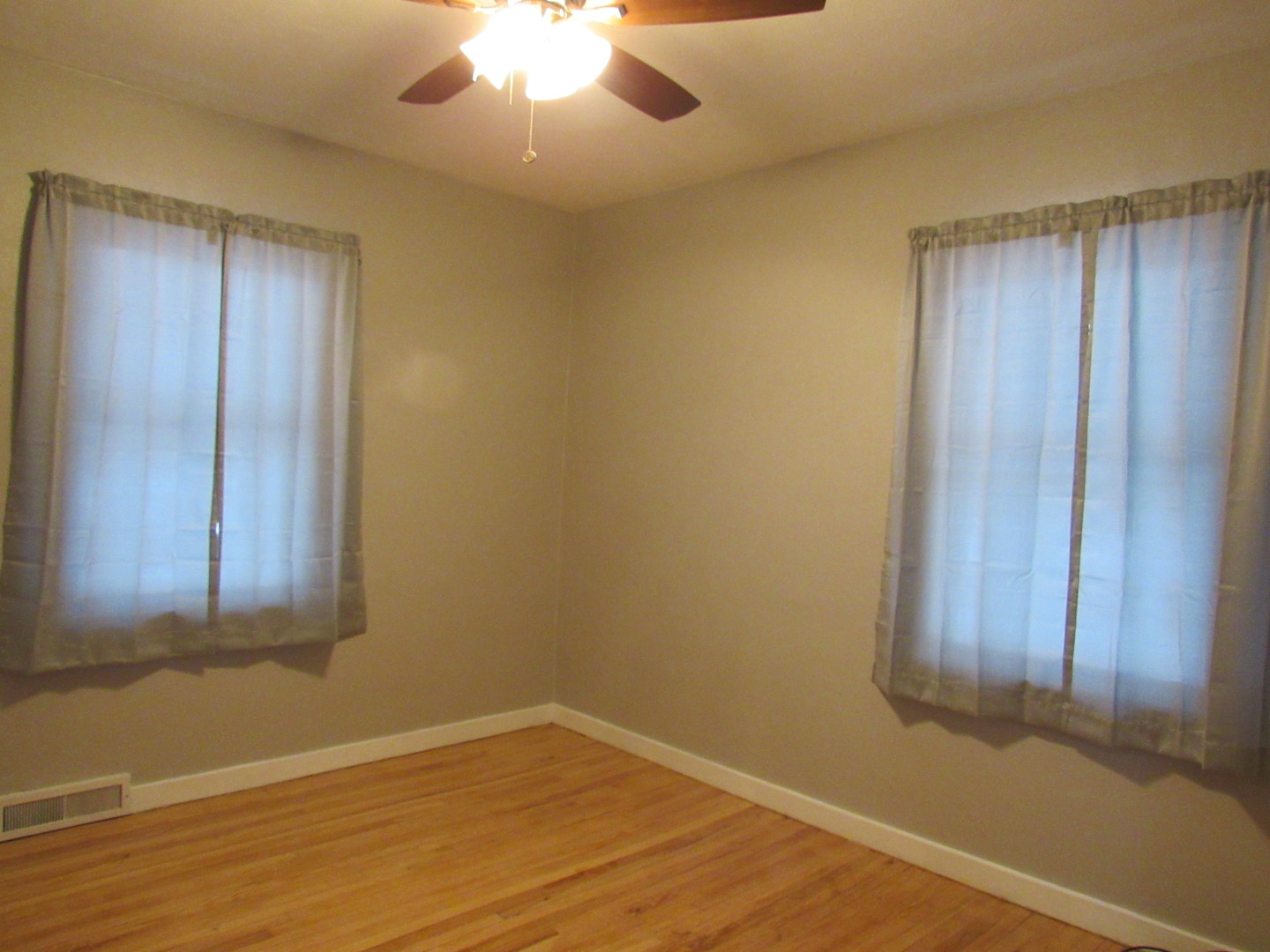 730 Lincoln Road Bettendorf, IA 52722 - Photo 10 of 13 an empty room with wooden floor and windows
