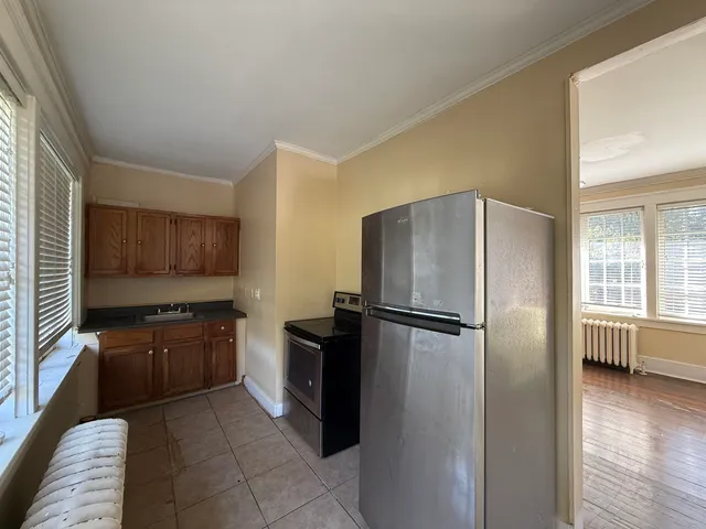 a kitchen with stainless steel appliances granite countertop a refrigerator a stove a sink and dishwasher