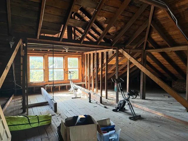 a view of a room with wooden floor