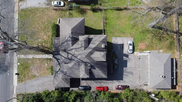 an aerial view of a house with a yard basket ball court and outdoor seating