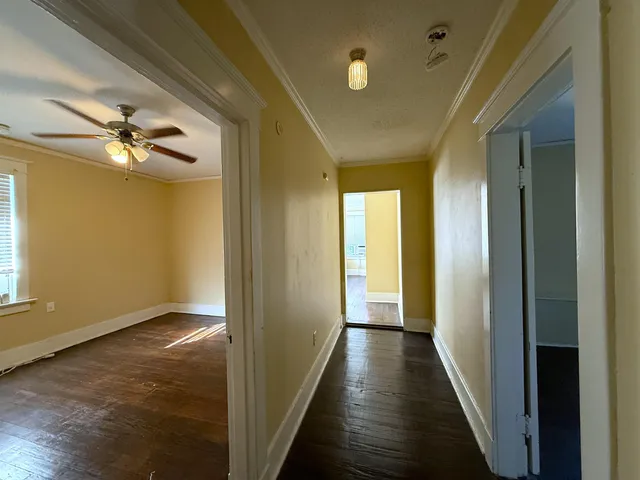 a view of a hallway with wooden floor