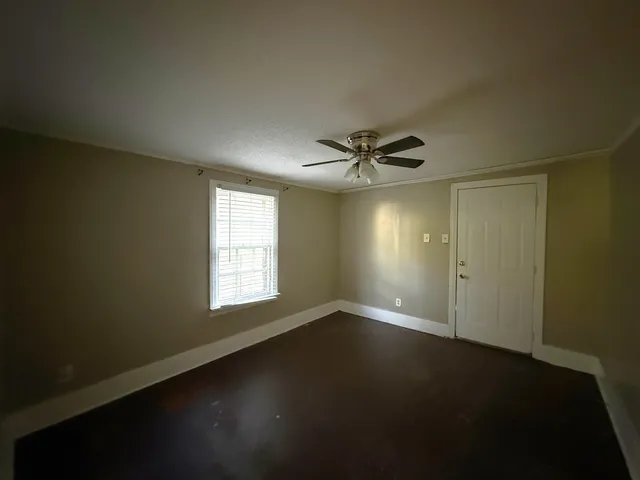 a view of a hallway with wooden floor and entryway