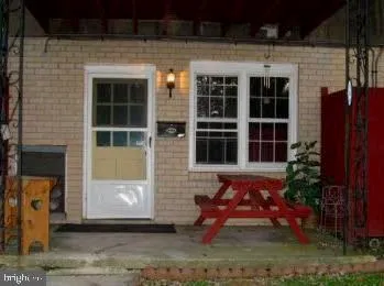 a front view of house with outdoor seating yard and barbeque oven