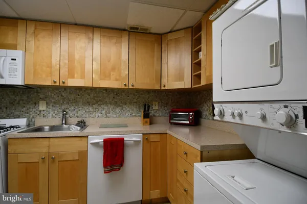a kitchen with a sink a stove and cabinets