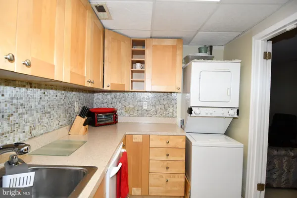 a kitchen with a white stove top oven and sink