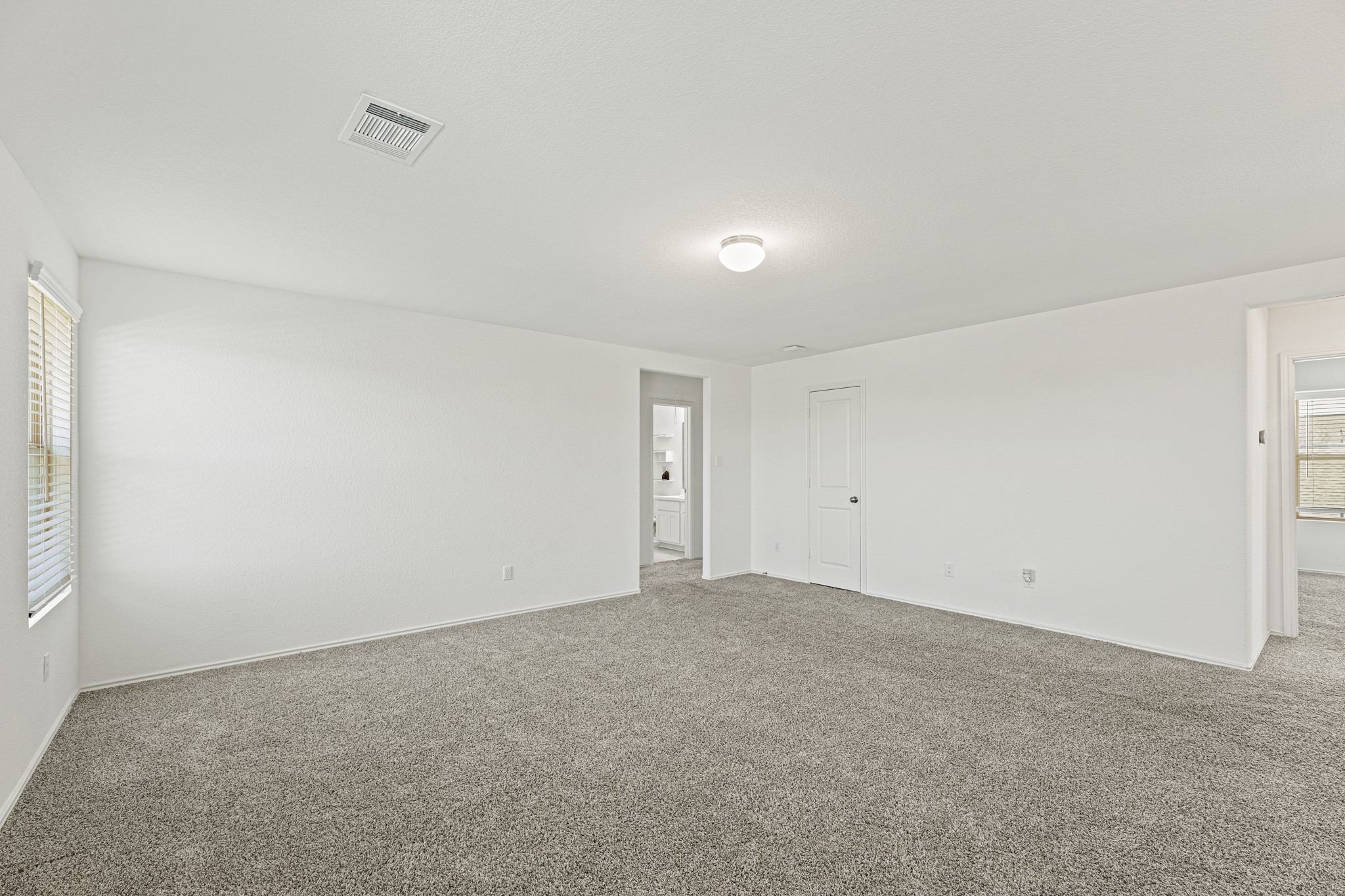 21317 Resource Road Pflugerville, TX 78660 - Photo 20 of 37 An airy bedroom with soft carpeting awaits new memories.