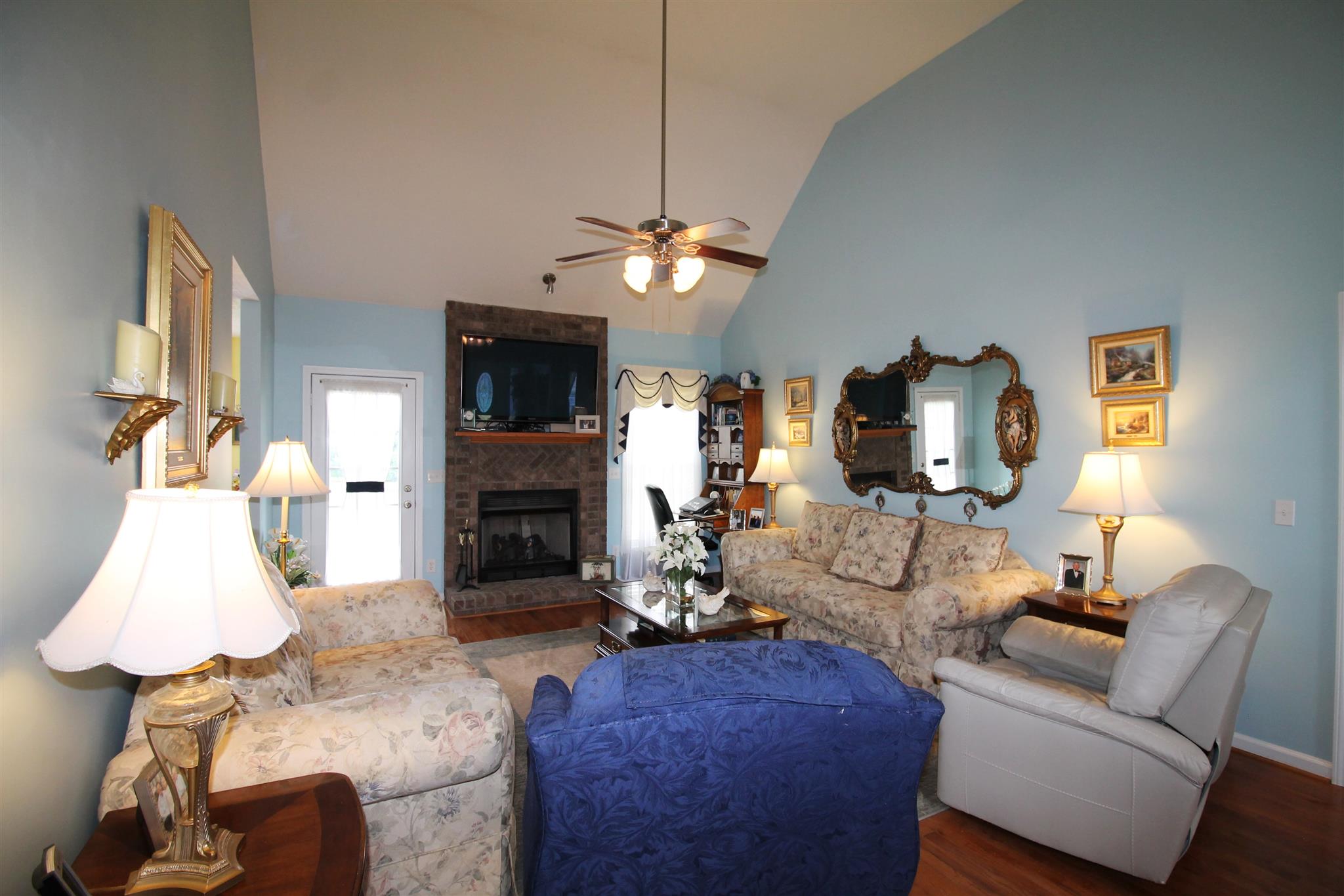 1182 Payne Road Portland, TN 37148 - Photo 9 of 27 a living room with furniture a fireplace and a flat screen tv