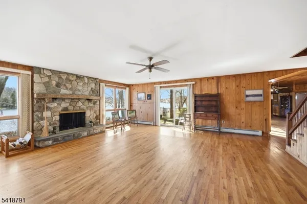 wooden floor fireplace and windows in an empty room
