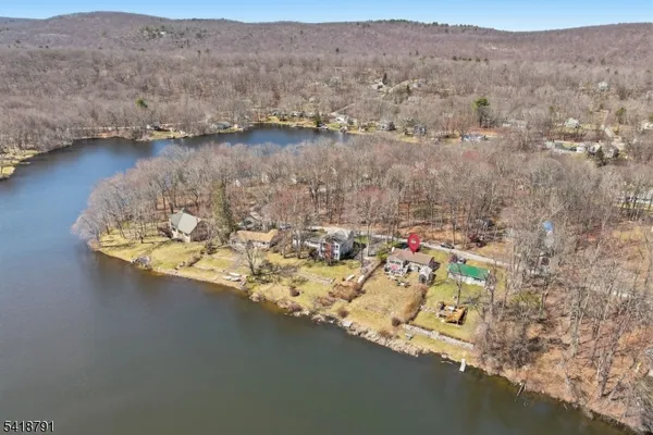 an aerial view of a house with a lake view