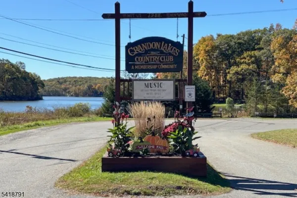 a sign board with buildings in the background