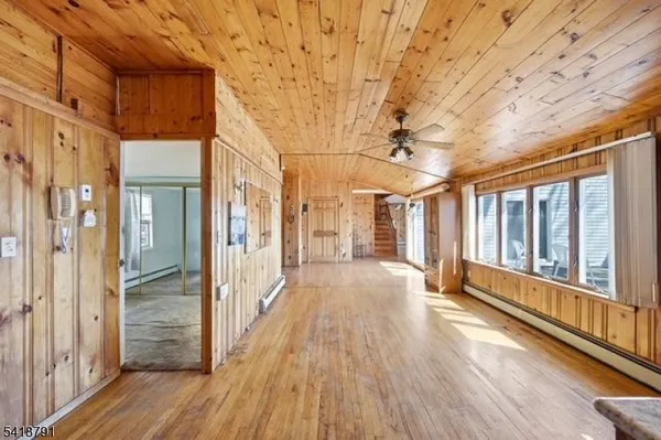 a view of a porch with wooden floor and windows