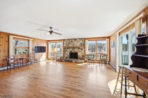 a view of a livingroom with furniture flat screen tv and wooden floor