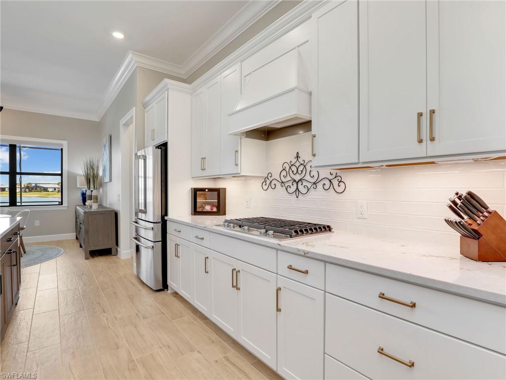 18412 Ridgeline Drive Estero, FL 33928 - Photo 17 of 50 a kitchen with stainless steel appliances white cabinets and a refrigerator