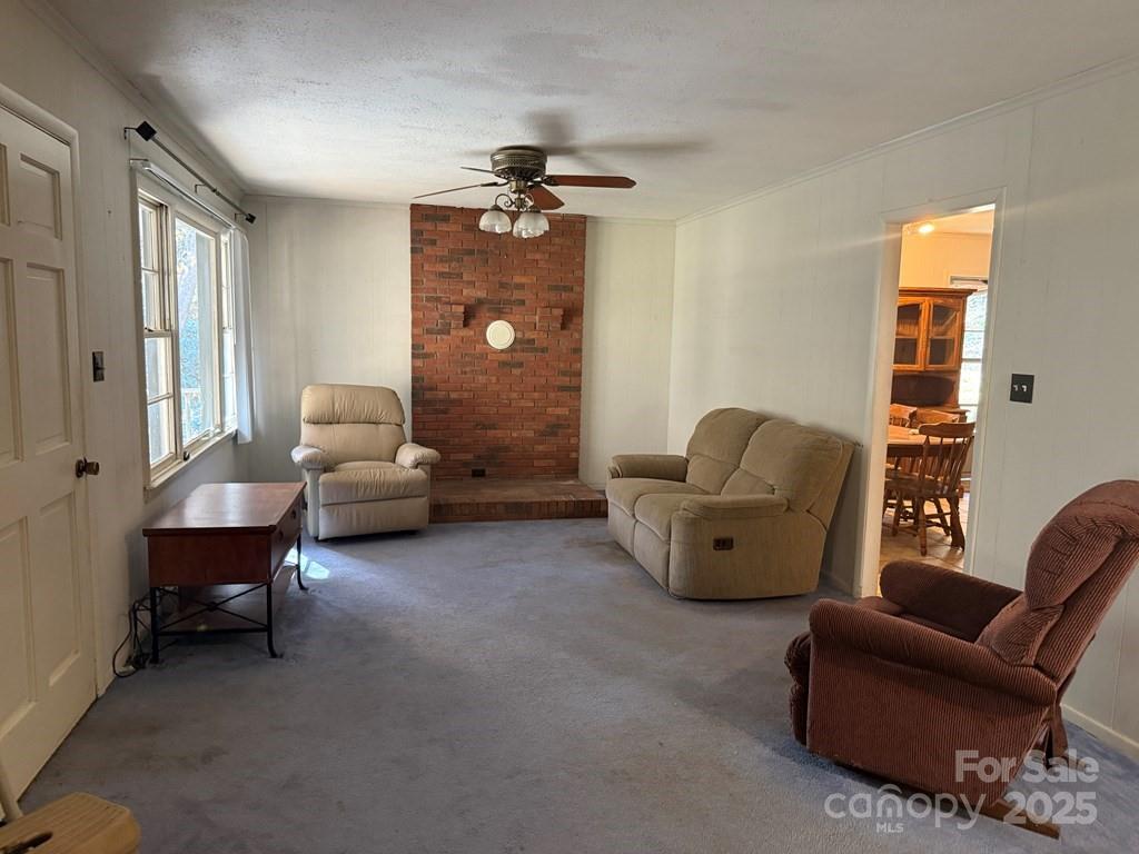 82 Merry Cove Road Sylva, NC 28779 - Photo 12 of 17 a living room with furniture and a chandelier