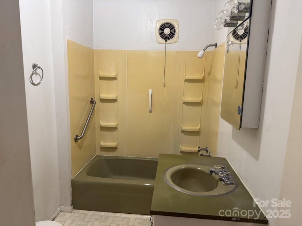 82 Merry Cove Road Sylva, NC 28779 - Photo 13 of 17 a bathroom with a sink a window and shower
