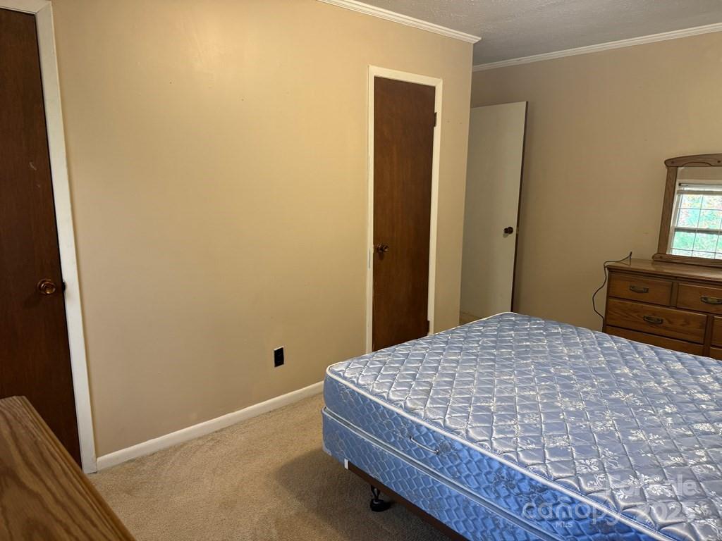 82 Merry Cove Road Sylva, NC 28779 - Photo 14 of 17 a bedroom with a bed and a dresser