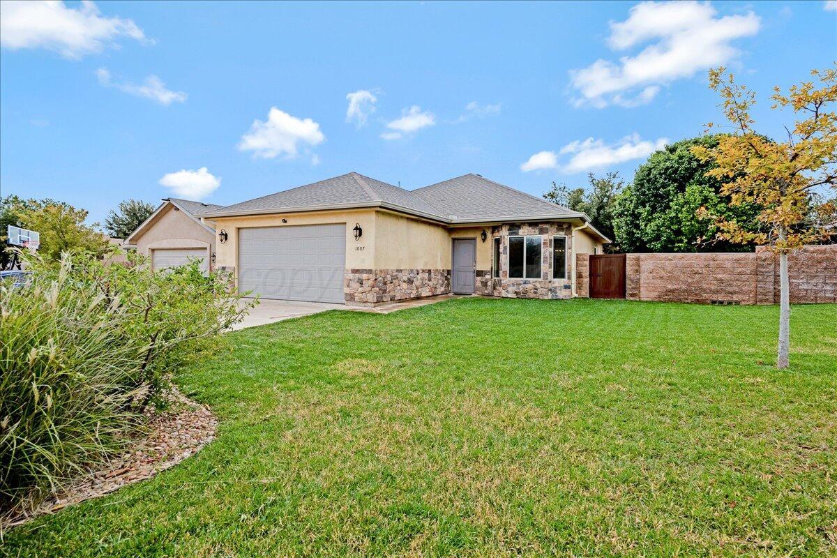 a view of a house with a big yard plants and large trees