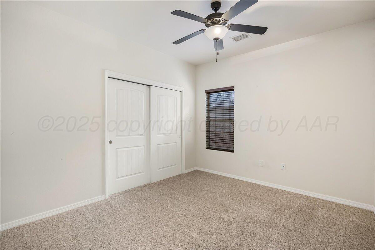 1007 Shiraz Boulevard Amarillo, TX 79124 - Photo 15 of 21 an empty room with windows and fan