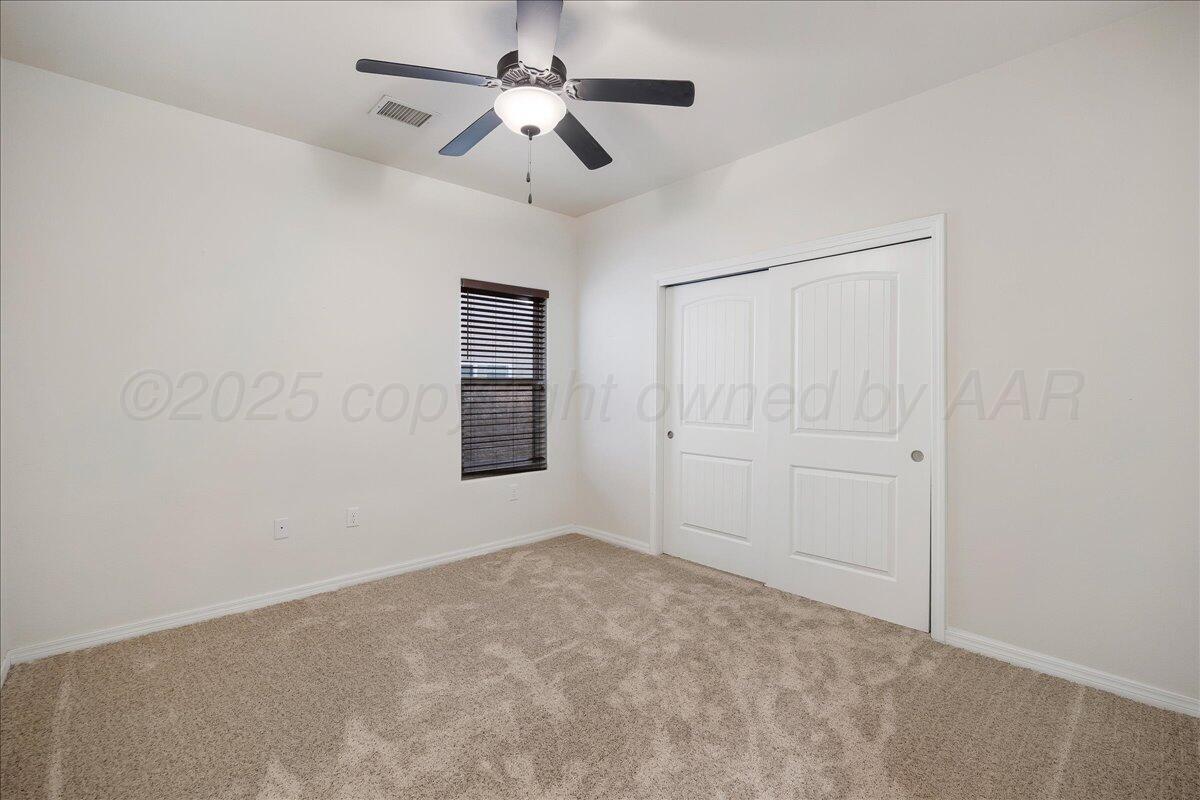 1007 Shiraz Boulevard Amarillo, TX 79124 - Photo 16 of 21 en empty room with ceiling fan and window
