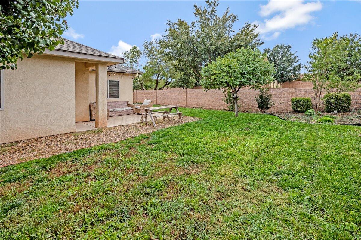 1007 Shiraz Boulevard Amarillo, TX 79124 - Photo 21 of 21 a view of a backyard with table and chairs and a fire pit