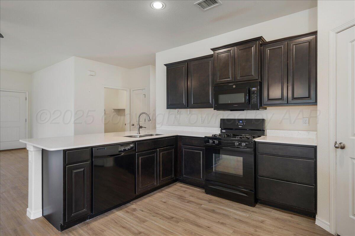 1007 Shiraz Boulevard Amarillo, TX 79124 - Photo 8 of 21 a kitchen with stainless steel appliances granite countertop a stove and a sink