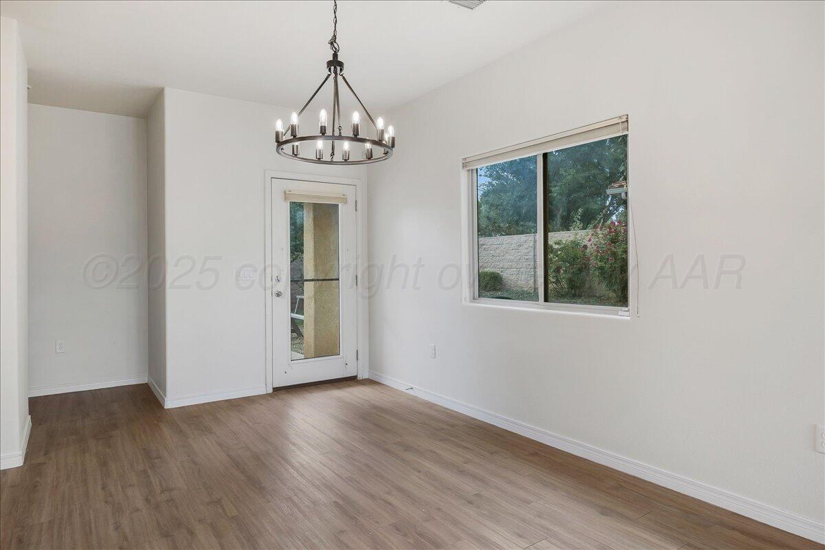 1007 Shiraz Boulevard Amarillo, TX 79124 - Photo 9 of 21 wooden floor in an empty room with a window