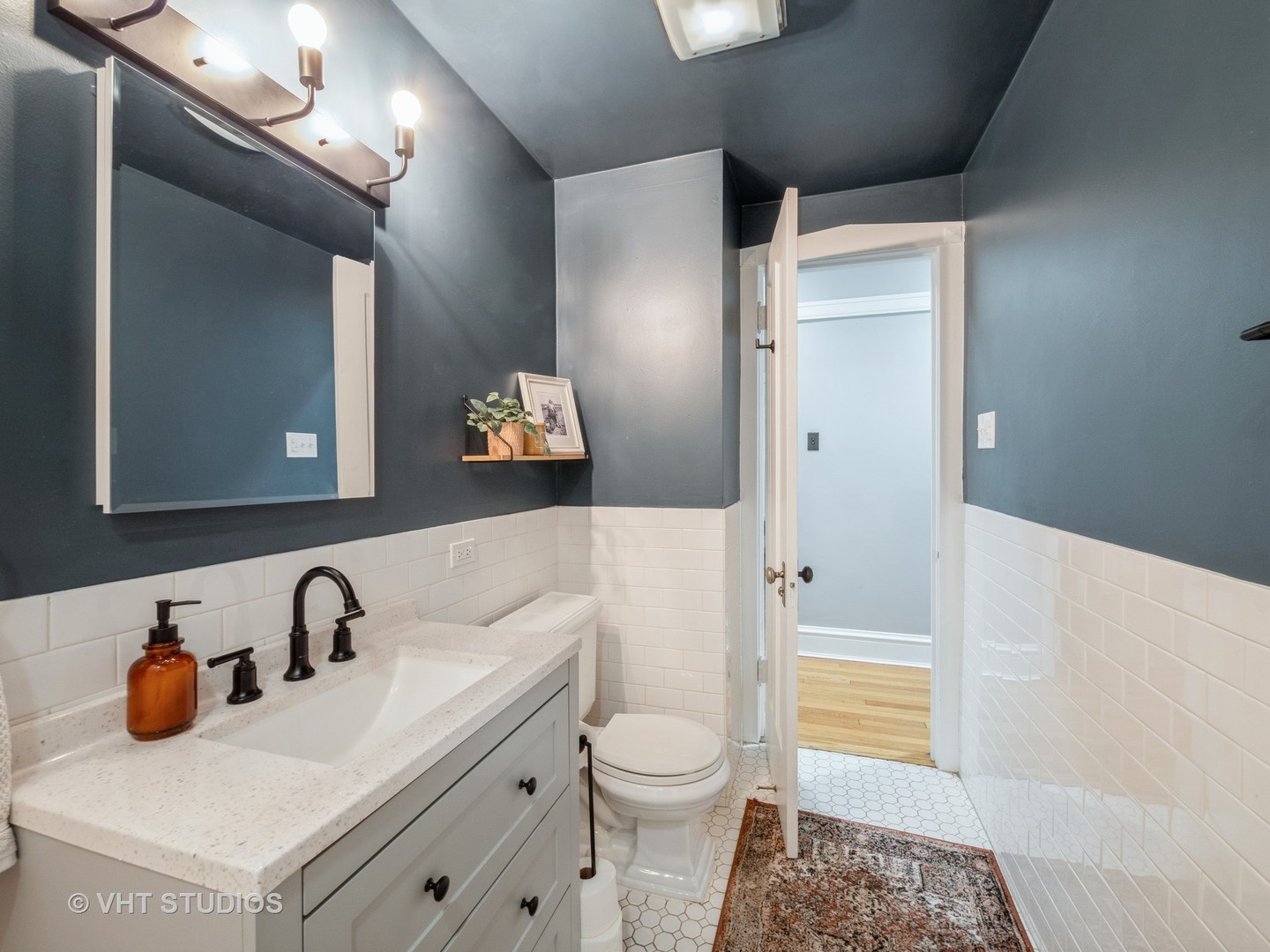 1440 West Summerdale Avenue, Unit 1 Chicago, IL 60640 - Photo 11 of 13 a bathroom with a sink and a mirror