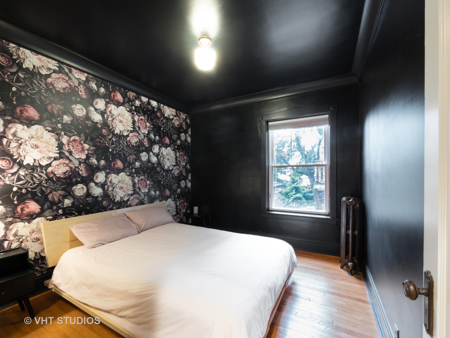 1440 West Summerdale Avenue, Unit 1 Chicago, IL 60640 - Photo 12 of 13 a bed sitting in a balcony next to a window