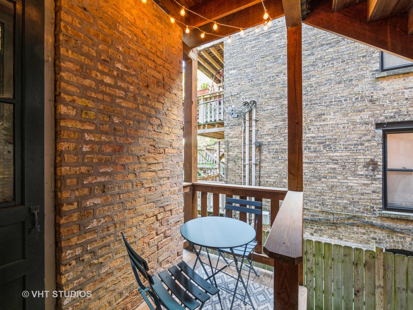 1440 West Summerdale Avenue, Unit 1 Chicago, IL 60640 - Photo 13 of 13 a balcony with table and chairs