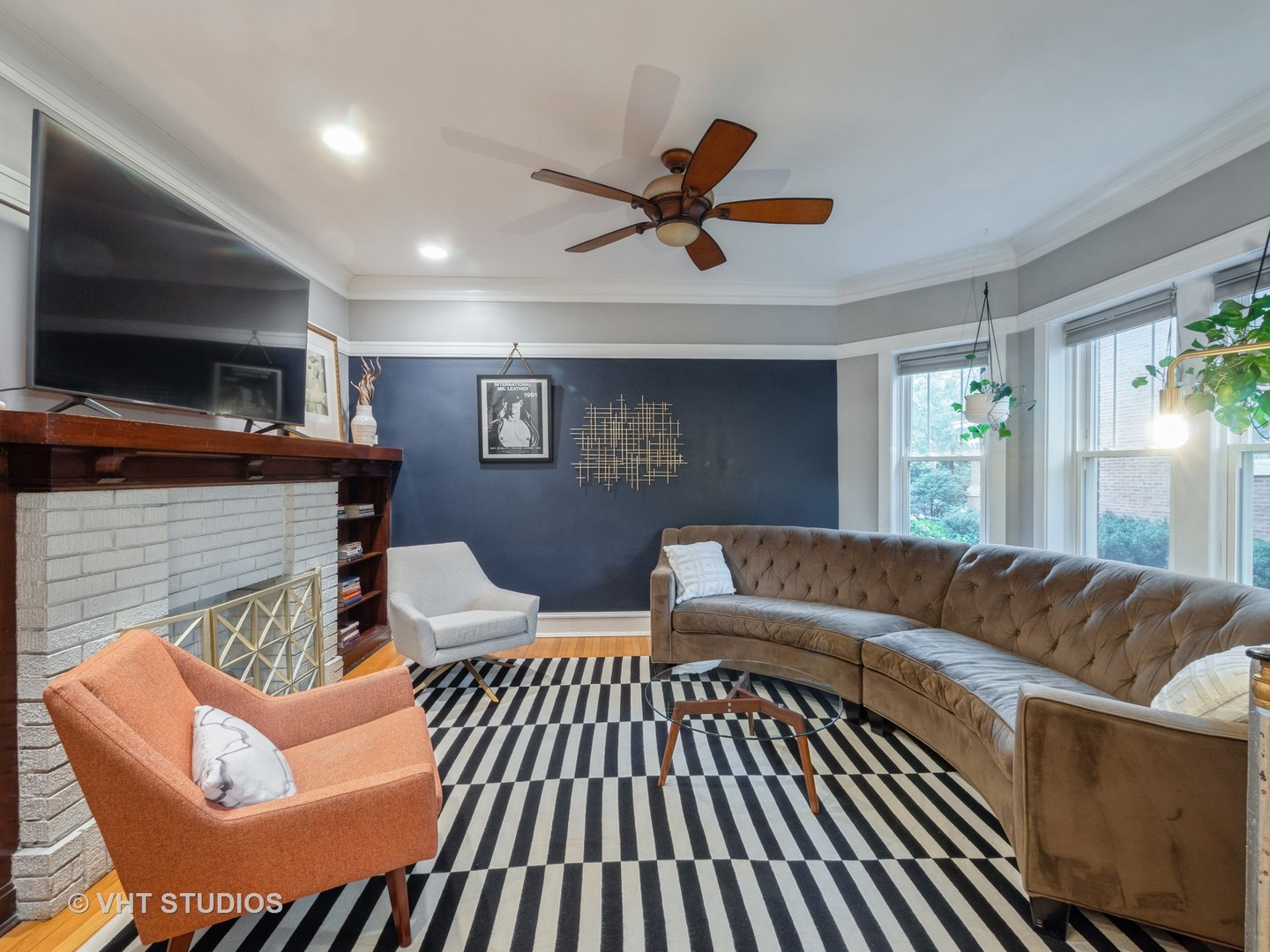 1440 West Summerdale Avenue, Unit 1 Chicago, IL 60640 - Photo 6 of 13 a living room with furniture a flat screen tv and a fireplace