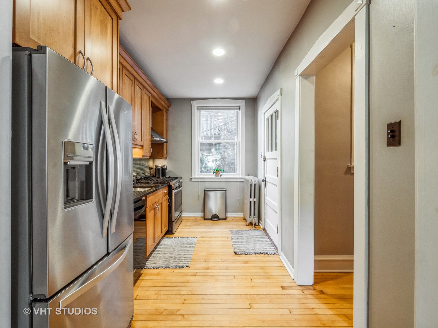 1440 West Summerdale Avenue, Unit 1 Chicago, IL 60640 - Photo 8 of 13 a kitchen with stainless steel appliances a refrigerator and a stove top oven