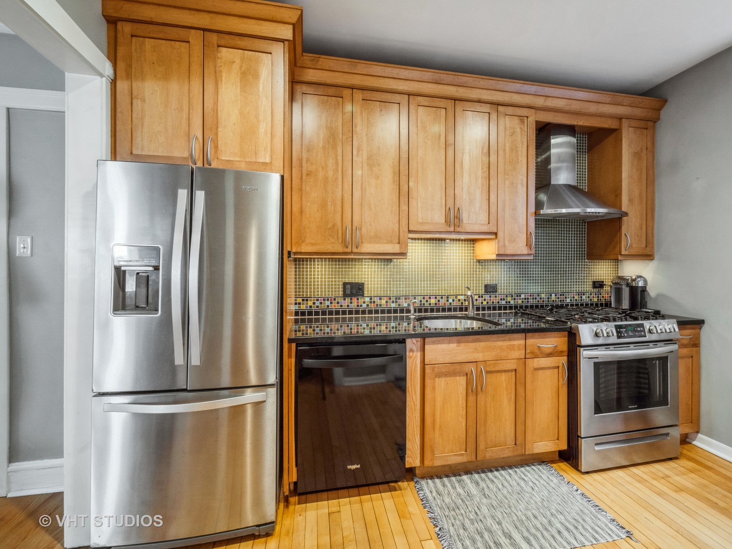 1440 West Summerdale Avenue, Unit 1 Chicago, IL 60640 - Photo 9 of 13 a kitchen with a refrigerator sink and cabinets