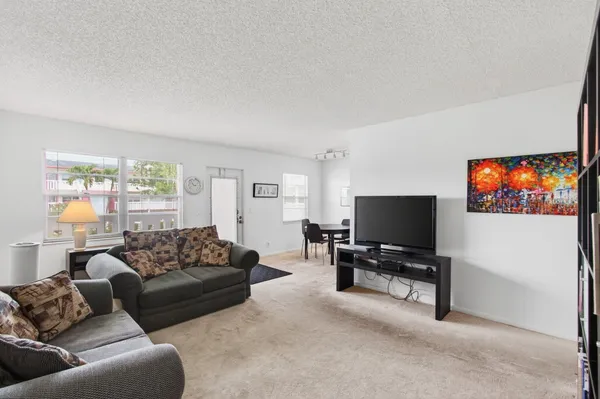 a view of a room with furniture and wooden floor