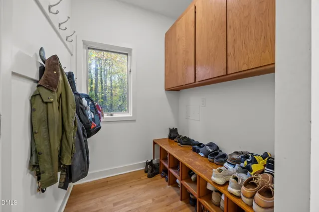 a kitchen with granite countertop a sink cabinets stainless steel appliances and a window