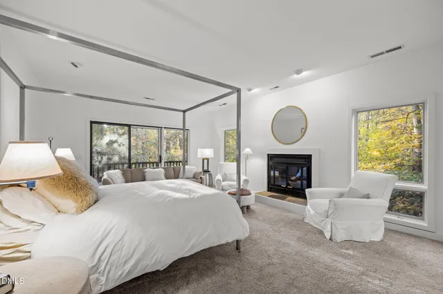 a bedroom with bed and a fireplace