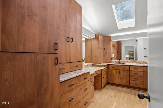 a spacious bathroom with a double vanity sink a mirror and a