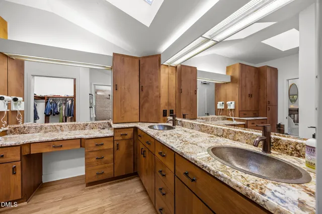 a bathroom with a sink double vanity granite and a mirror