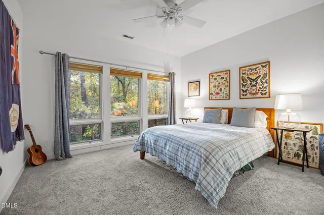 a bedroom with a bed and a large window