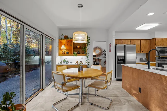 an open kitchen with dining table and chairs