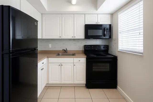 a kitchen with a refrigerator stove and microwave