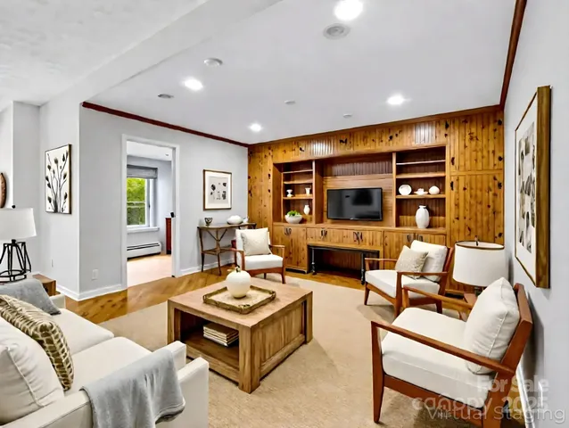 a living room with furniture kitchen view and a large window