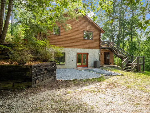 a view of a house with a yard and tree